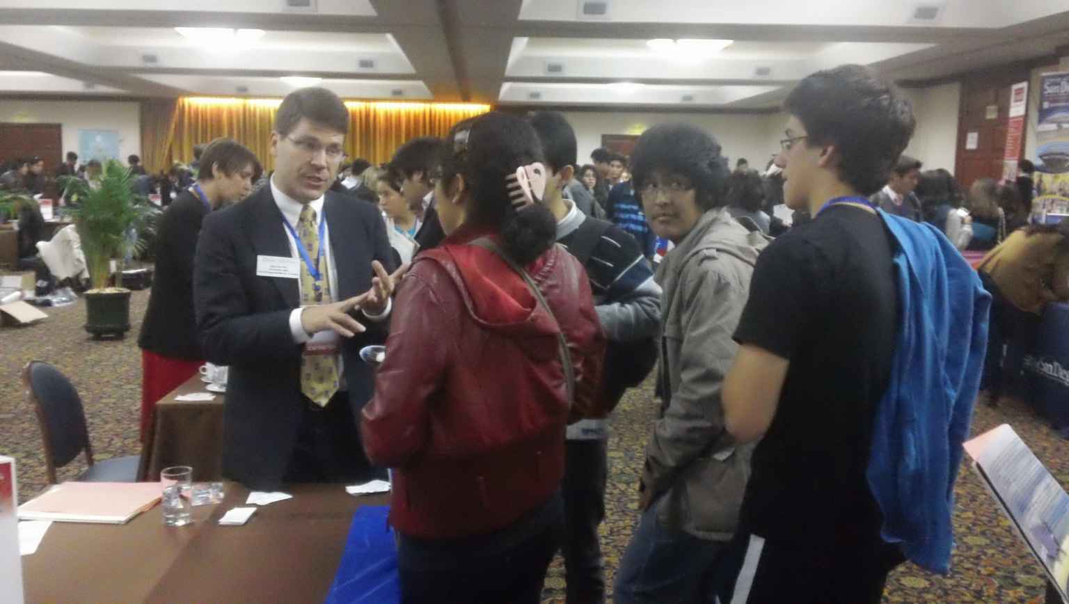International students at US college fairs meeting with advisors and representatives 