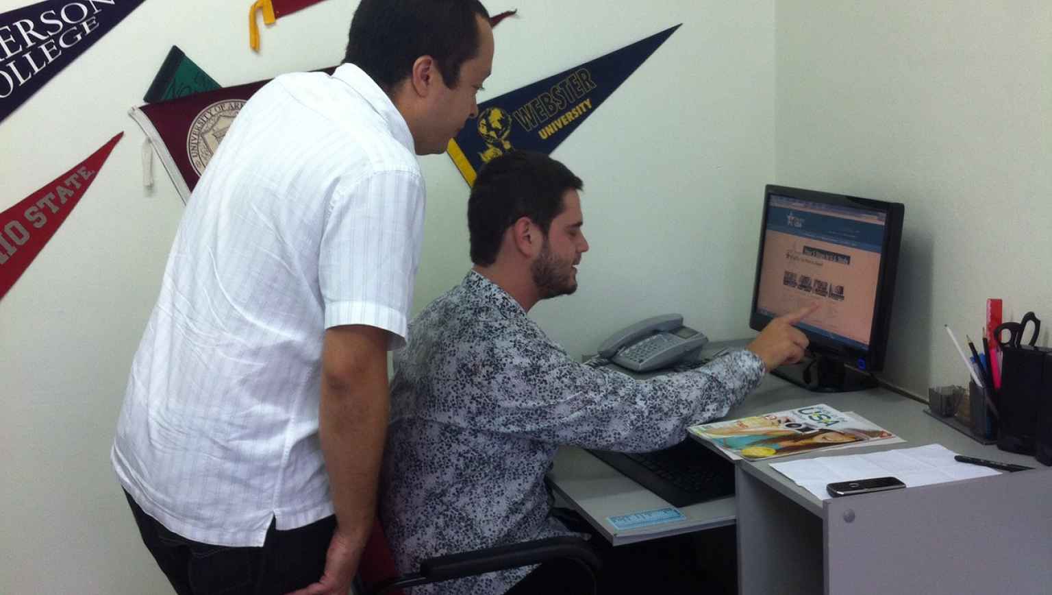 International student and advisor searching on EducationUSA website for study opportunities
