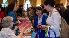 A U.S. higher education representative chats with students during a recent EducationUSA fair.
