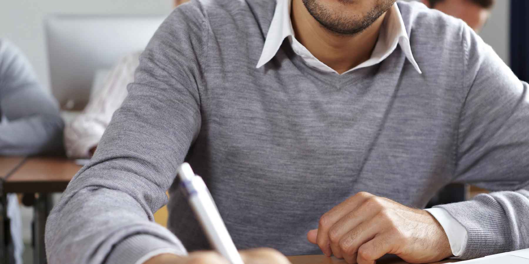 international student taking notes on financial aid research 