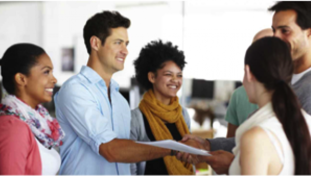 Group of young adults shaking hands